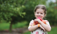 A girl holds some apples at Apple Jack Orchards