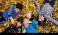 Five children play in a pile of leaves in this Picture Plymouth photo contest winner.