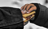 Two hands hold a smore.