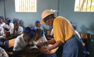 A representative of Days for Girls teaches Haitian girls about menstrual hygiene products.