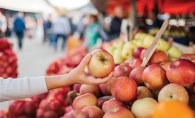 Someone shopping fresh apples at a farmer's market.
