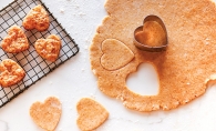 Heart-shaped cookies cut out of a piece of dough