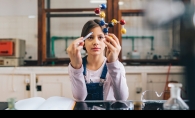 A girl performs an experiment at the Young Scientist Roundtable.