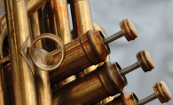 A close-up shot of the pistons of a trumpet.