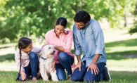 family with dog in park