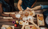 A group of friends enjoys happy hour food and drink.