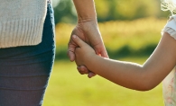 A child holds their parent's hand at Sensory Friendly Sundays at French Regional Park.