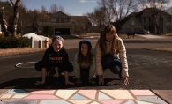 Ann Grocholski and her kids pose with their sidewalk chalk mural.