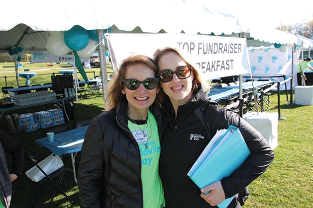 Two women pose for a photo at the Parkinson's Foundation's Moving Day.