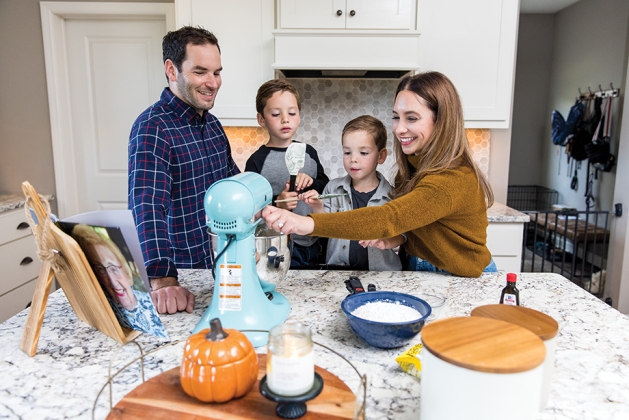 Brad, Gabe, Jonah and Rachel Ingber making a cookie recipe from the book she made for her grandmother-in-law.