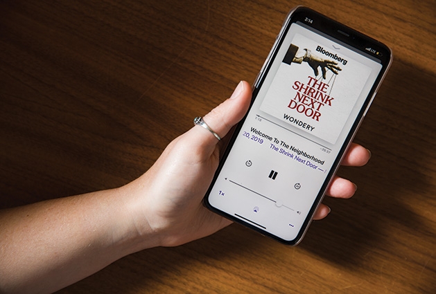 The Shrink Next Door A person holding a phone listens to the New York Times podcast "The Shrink Next Door."
