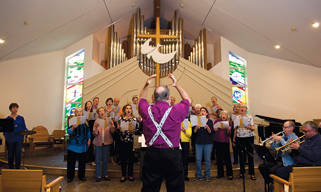 The congregation at St. Barnabas Center for the Arts sings.