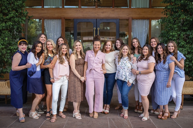 Stephanie Flies—wearing the pink jumpsuit in center—with Twin Cities Mom Collective.