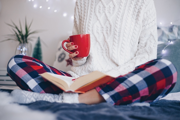 Woman reading a book during the winter.