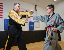World Taekwondo Academy grand master Kevin Kastelle trains a child with special needs.