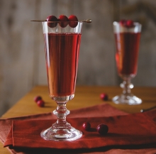 A winter cocktail featuring sparkling wine and cranberry liqueur.