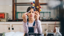 A girl performs an experiment at the Young Scientist Roundtable.