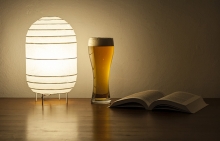 A glass of beer sits next to a copy of "The Lager Queen of Minnesota"