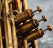 A close-up shot of the pistons of a trumpet.
