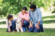 family with dog in park