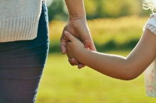 A child holds their parent's hand at Sensory Friendly Sundays at French Regional Park.