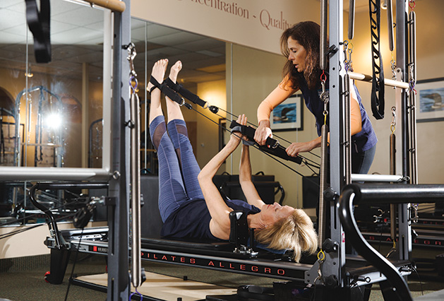 Sarah Eigenmann uses the reformer machine at Pilates MN in Wayzata