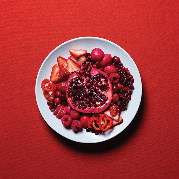 A variety of healthy, red foods including pomegranate, apples, berries, radishes and more